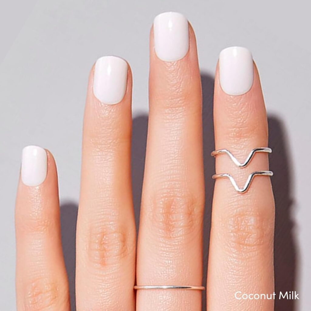 Coconut Milk press-on nails – glossy white square nails styled with minimalist silver rings